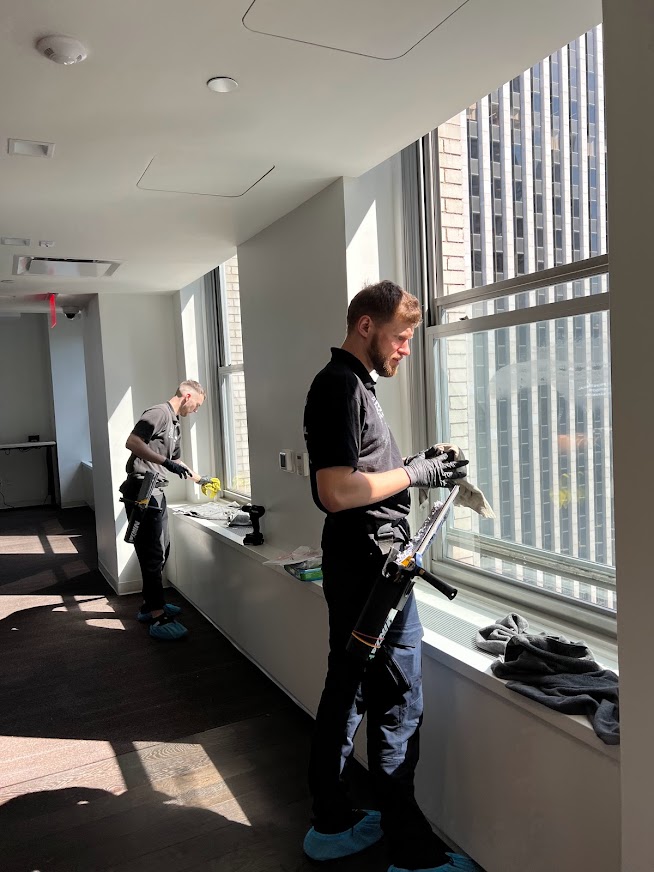 Professional window cleaner in an office in Manhattan, New York