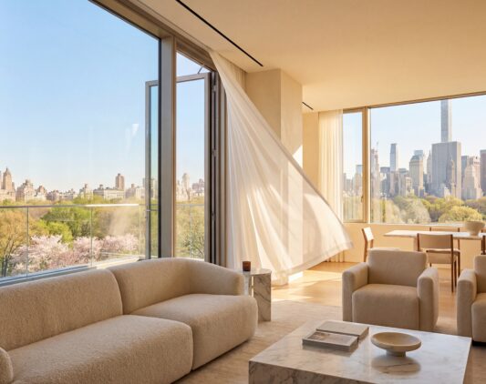 Luxury NYC penthouse interior with a floor-to-ceiling window cracked open, white curtains blowing in the spring breeze, and a view of the Manhattan skyline.