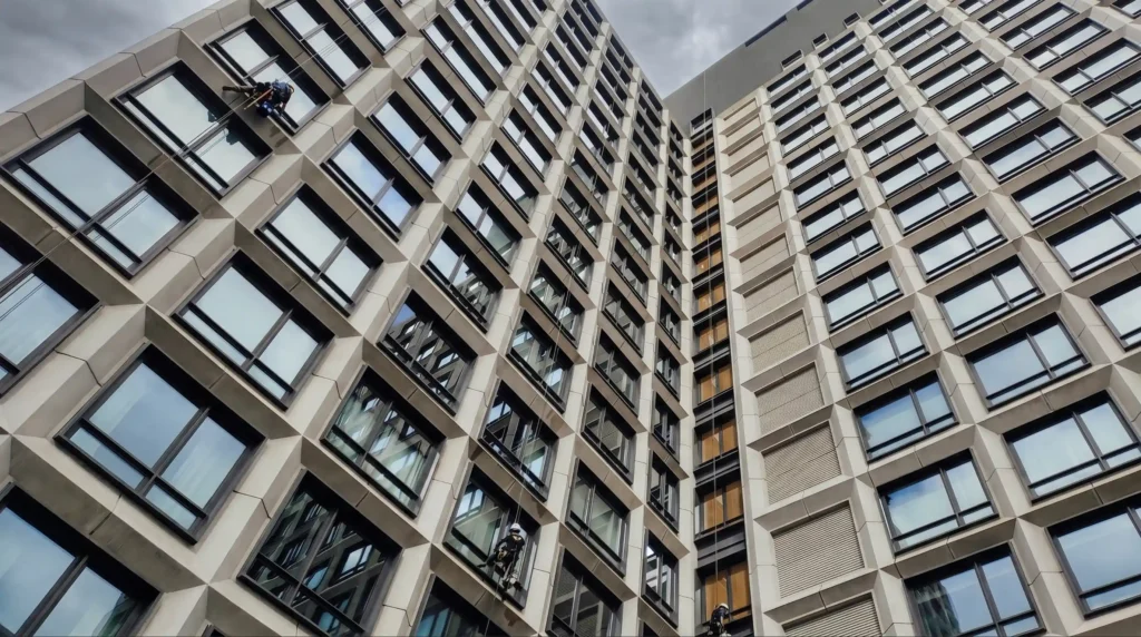 Big Apple Window Cleaning company rope access team washing windows on a high-rise building in New York