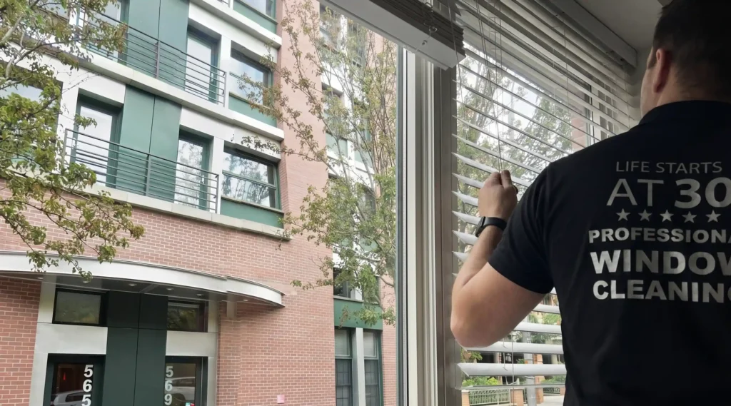 Technician inspecting a double-hung window before balance spring repair