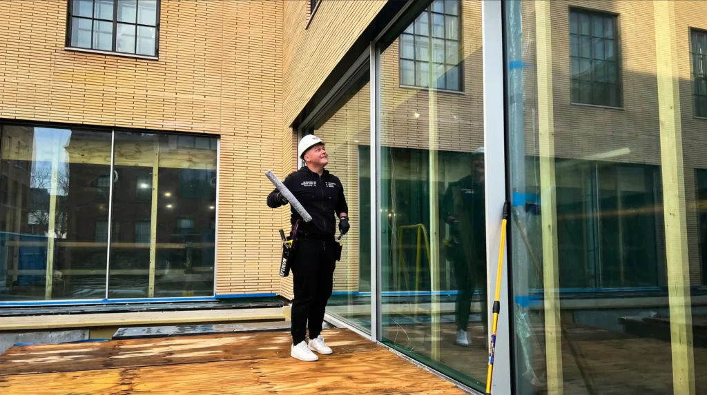 BAWC technician preparing commercial window cleaning for large glass panels on a New York building