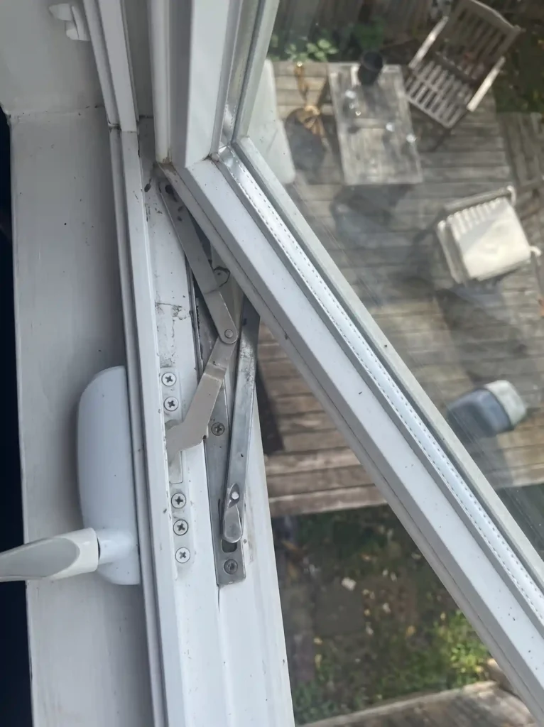 Installed casement window crank operator with arm mechanism on an open window
