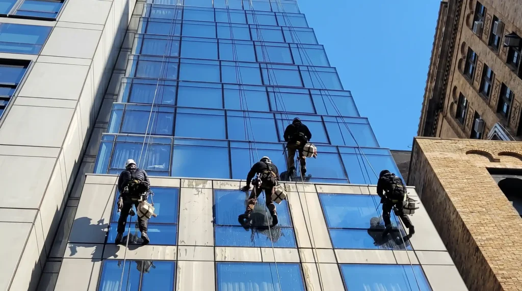 Rope access BAWC team cleaning commercial building windows in New York City