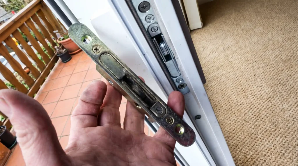 Old mortise lock removed during patio door lock replacement