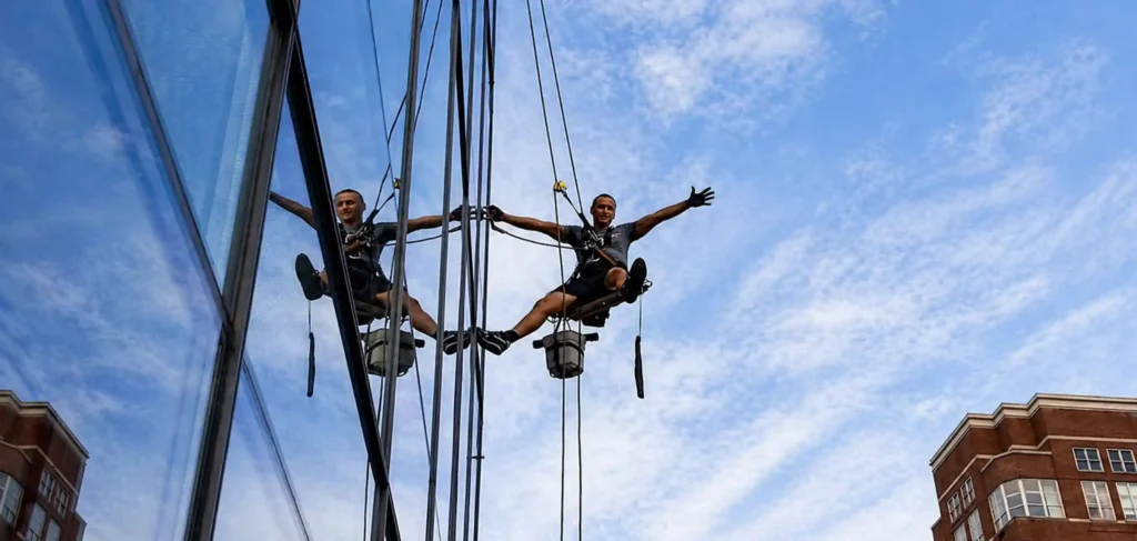 Rope access technicians working on a corporate building window cleaning program in New York