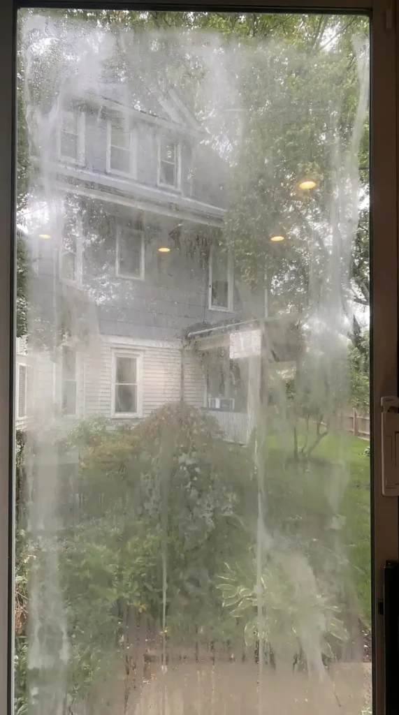 Foggy house window with failed seal inspected before replacement by Big Apple Window Cleaning company