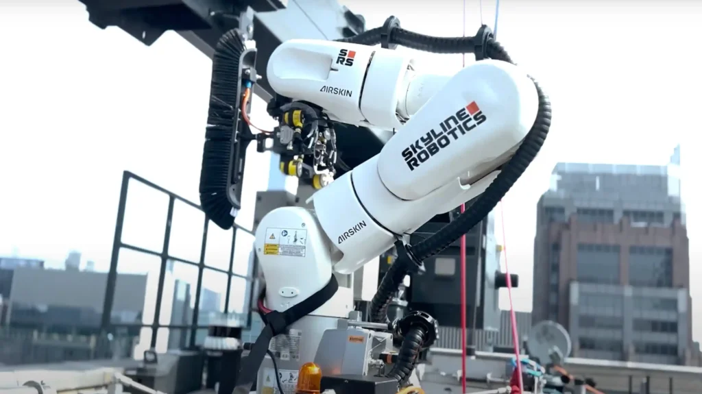 Skyline Robotics Ozmo robotic arm cleaning high-rise windows on a New York