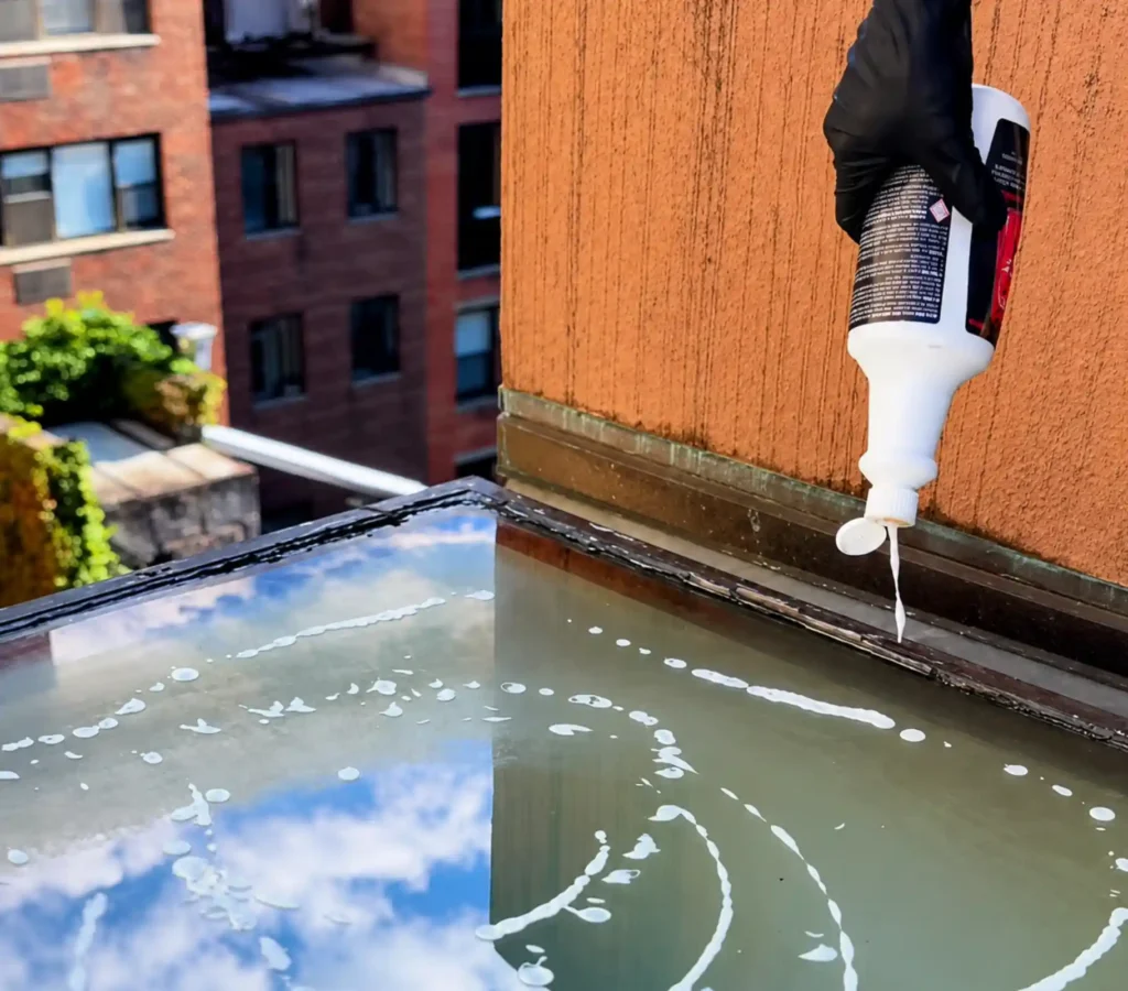 Window cleaner solution applied to exterior glass before washing